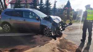 miejsce wypadku drogowego, na drodze stoją policjanci oraz strażacy. widać rozbite samochody. Na miejsce wylądował śmigłowiec pogotowia, w tle obok śmigłowca widać zaparkowane radiowozy policji i straży . Policjanci opisują uszkodzenia pojazdów