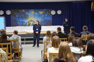 policjanci rozmawiają z dziećmi, dzieci siedzą na krzesłach.